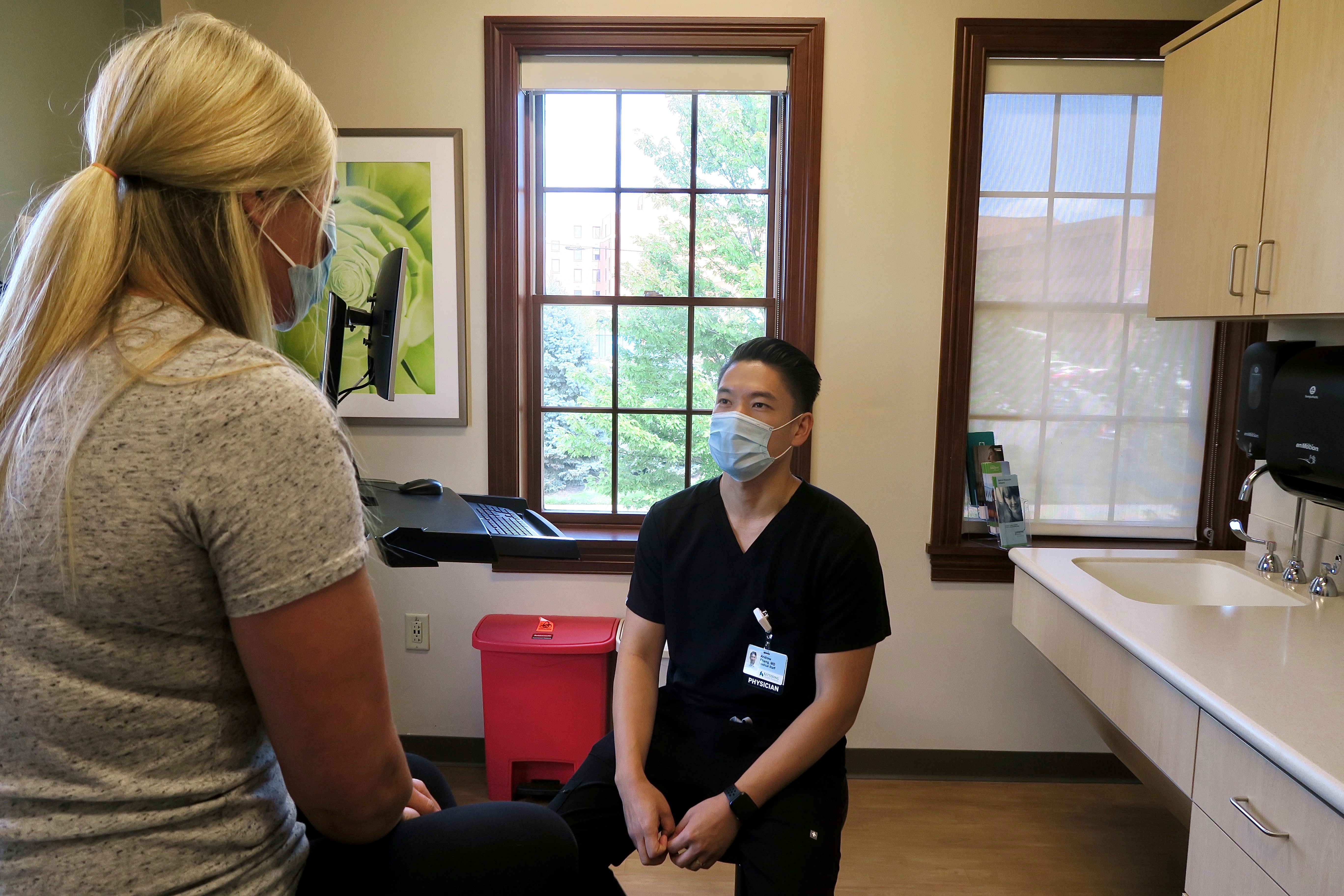 Dr. Andrew Chang talks with a patient