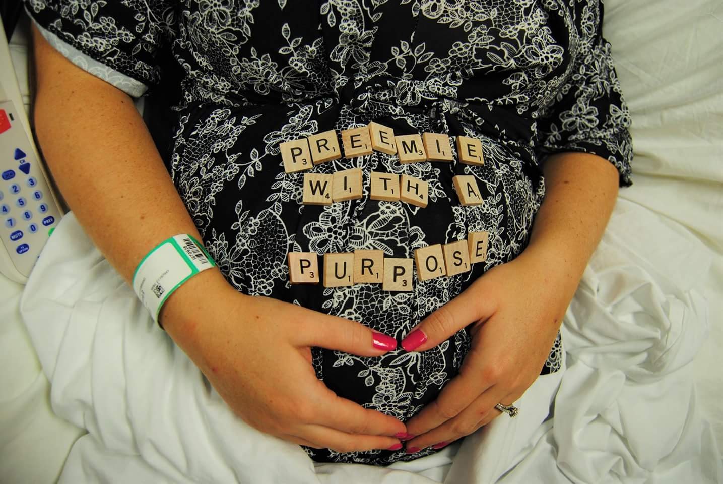 Bethanie Shepherd's pregnant belly with scrabble letters spelling out "premie with a purpose"