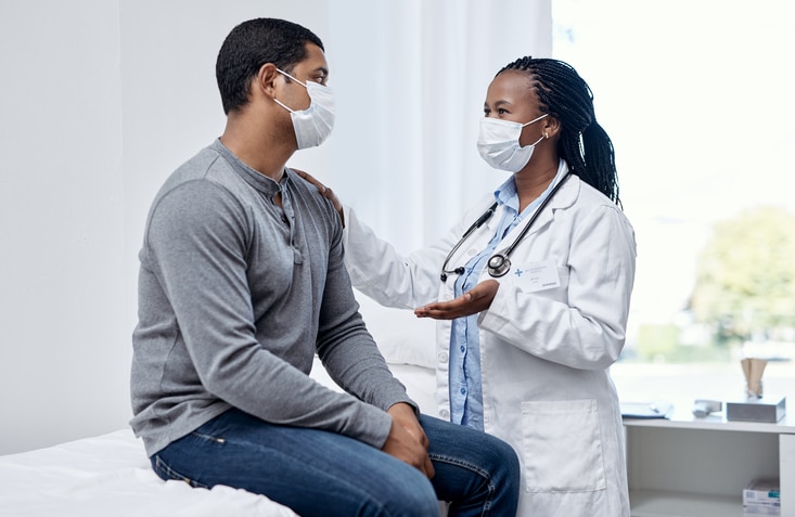doctor talks with patient during appointment
