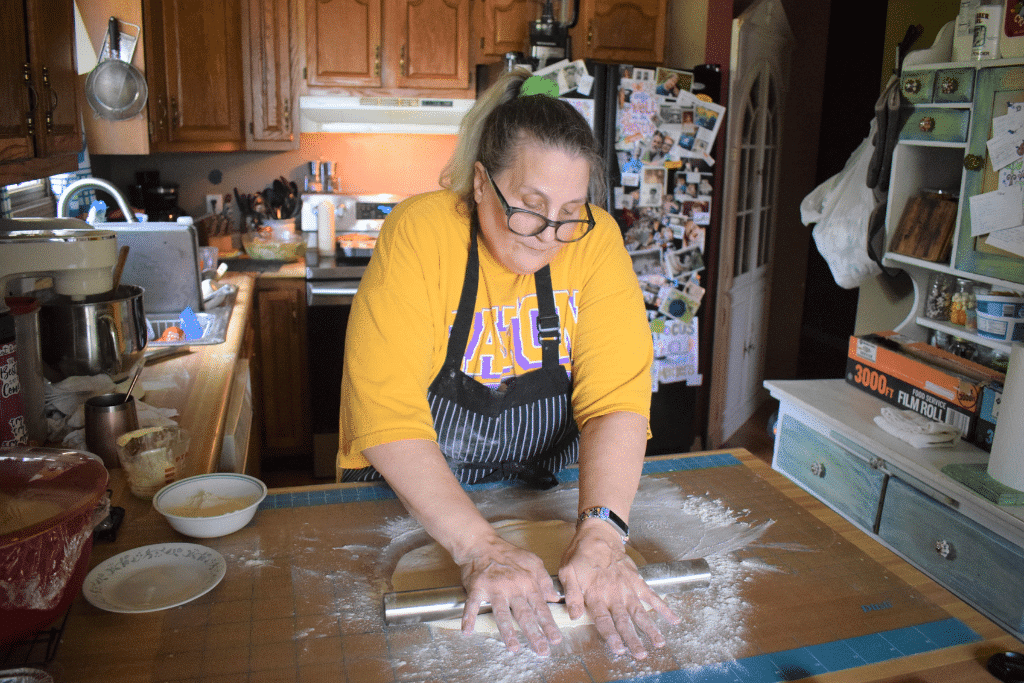 Woman rolls out dough by hand