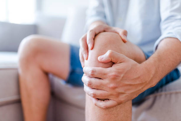 joint health: person holds knee in pain