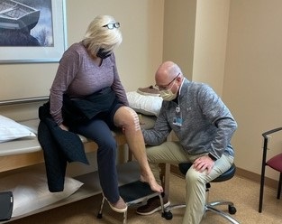 Dr. Michael Walker checks Diane Hansen knee after surgery