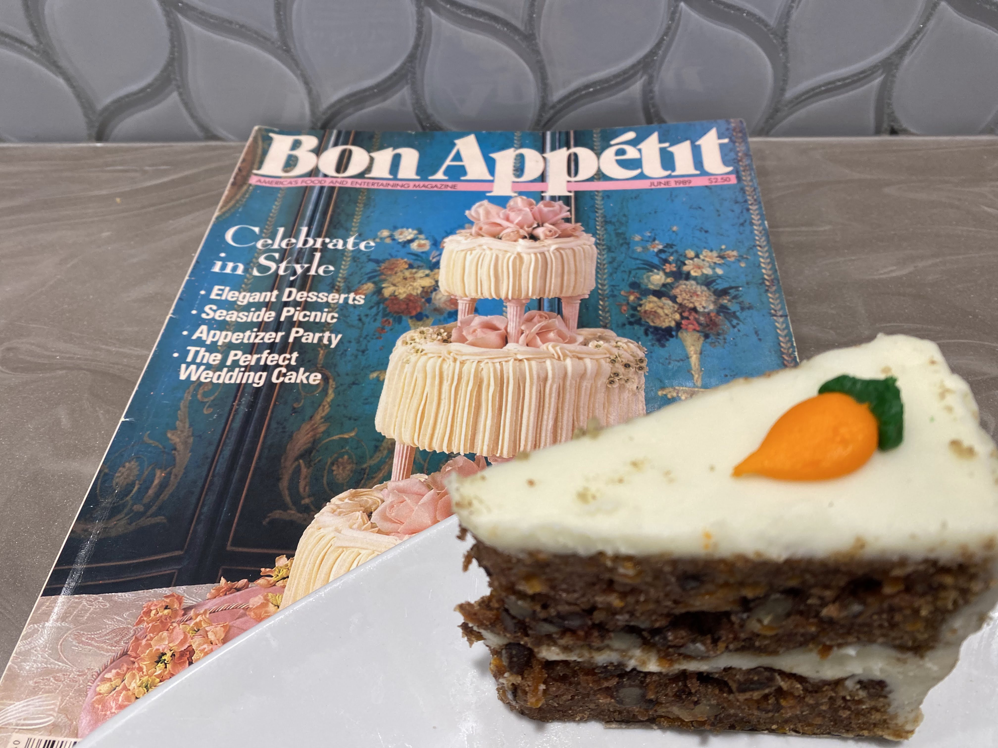 A slice of carrot cake on top of a magazine